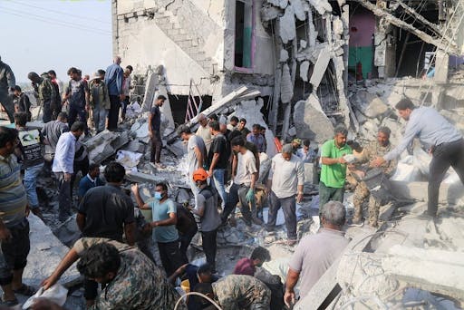 Iranian citizens go to the site where a Tomahawk missile struck an elementary school. (Photo courtesy of Wikimedia Commons)