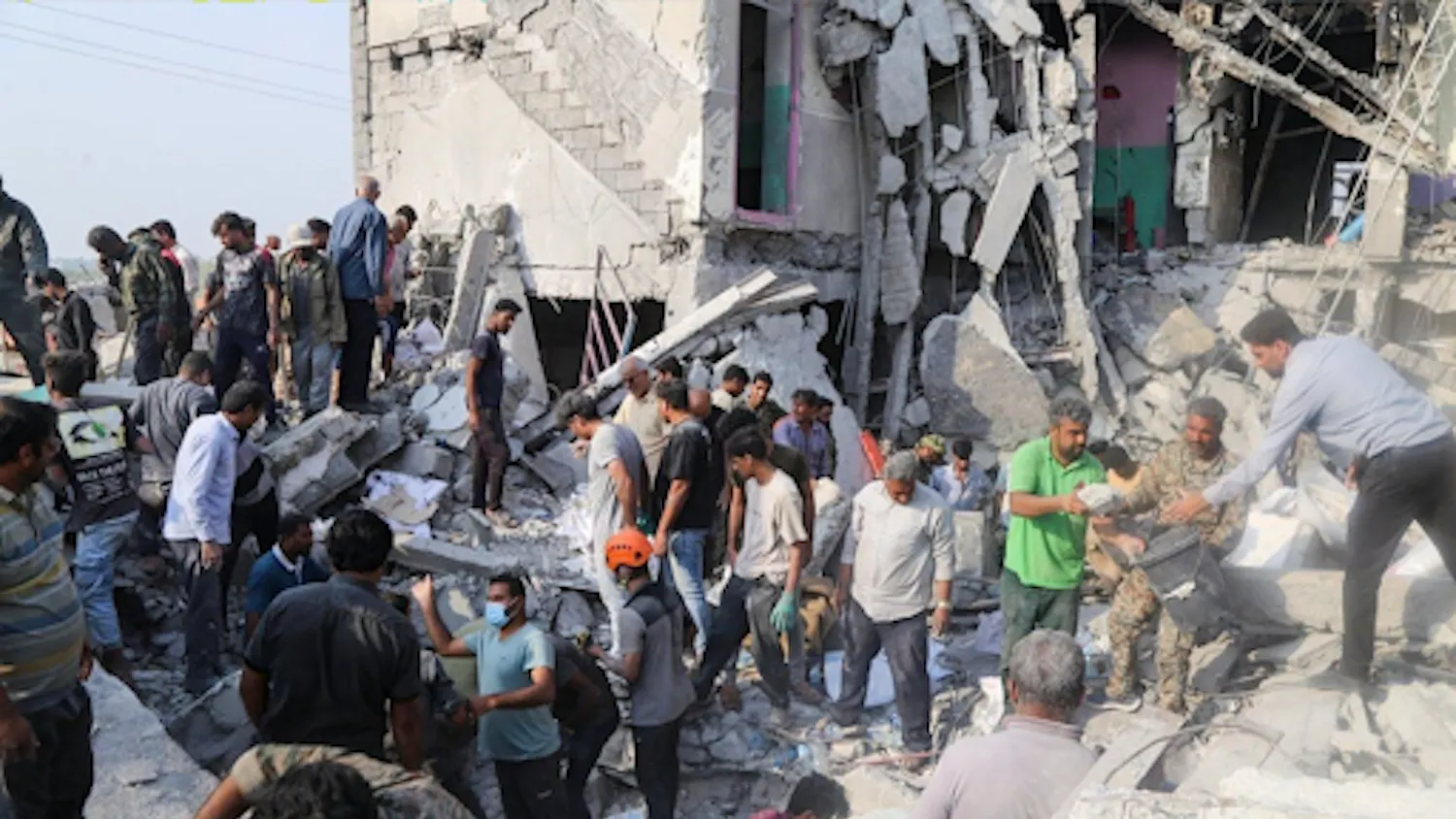Iranian citizens go to the site where a Tomahawk missile struck an elementary school. (Photo courtesy of Wikimedia Commons)