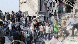 Iranian citizens go to the site where a Tomahawk missile struck an elementary school. (Photo courtesy of Wikimedia Commons)