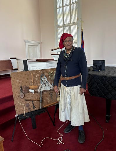 Leon Brooks explains the function of various ship artifacts to attendees. (Photo by Isabella McHugh)