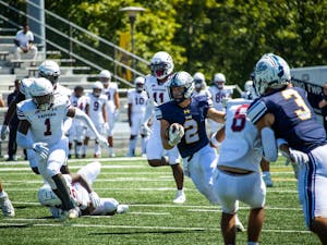 Junior running back Jayson Schmidt on a carry (Photo courtesy of Shane Gillespie / Photo Editor).
