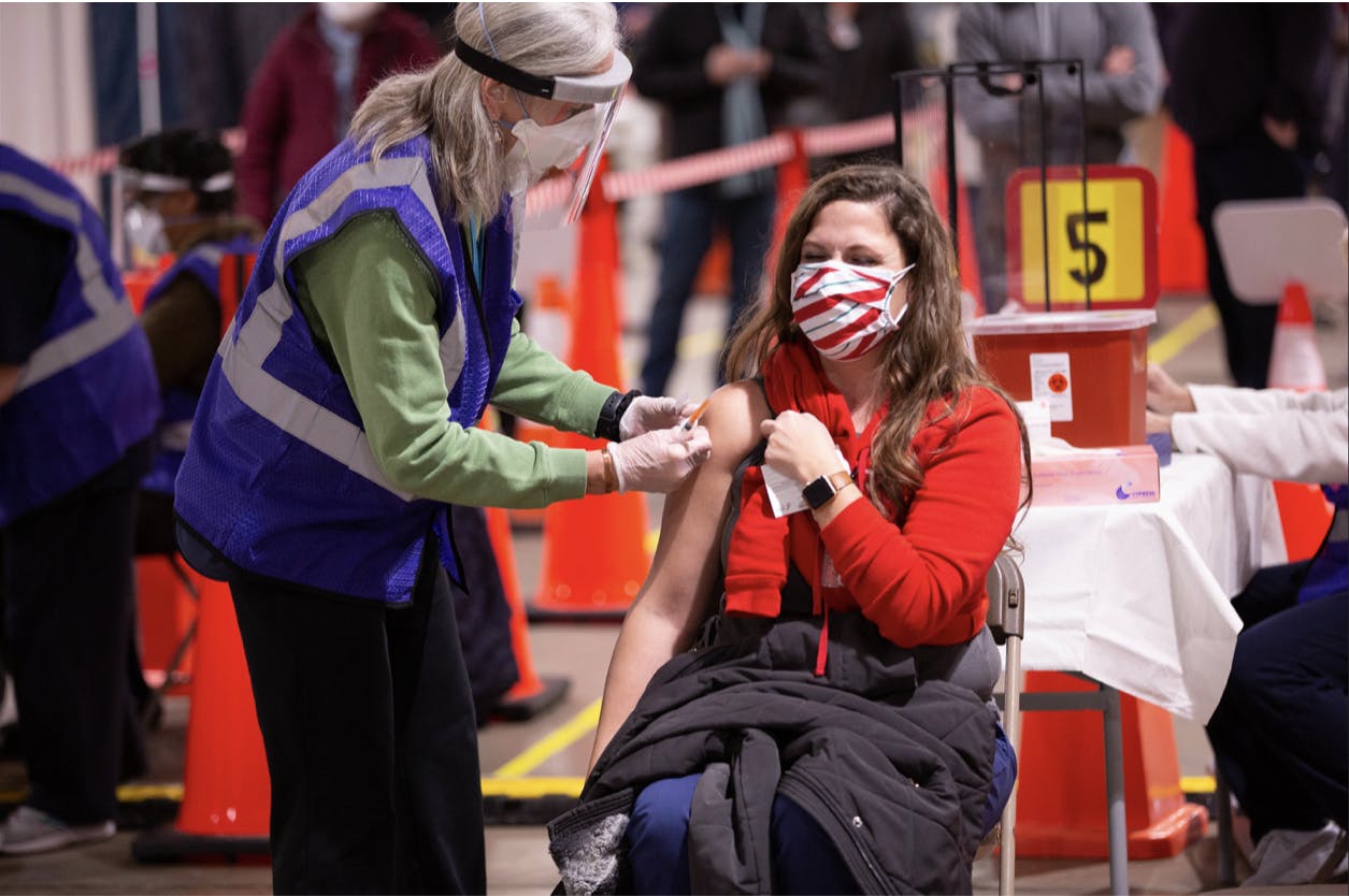 A frontline healthcare worker in Baltimore County, Md. received the first dose of the Moderna Covid-19 vaccine on Dec. 23, 2020. Vaccine rollout continues with the pandemic as billions of doses are distributed worldwide (Baltimore County Government / Flickr). 