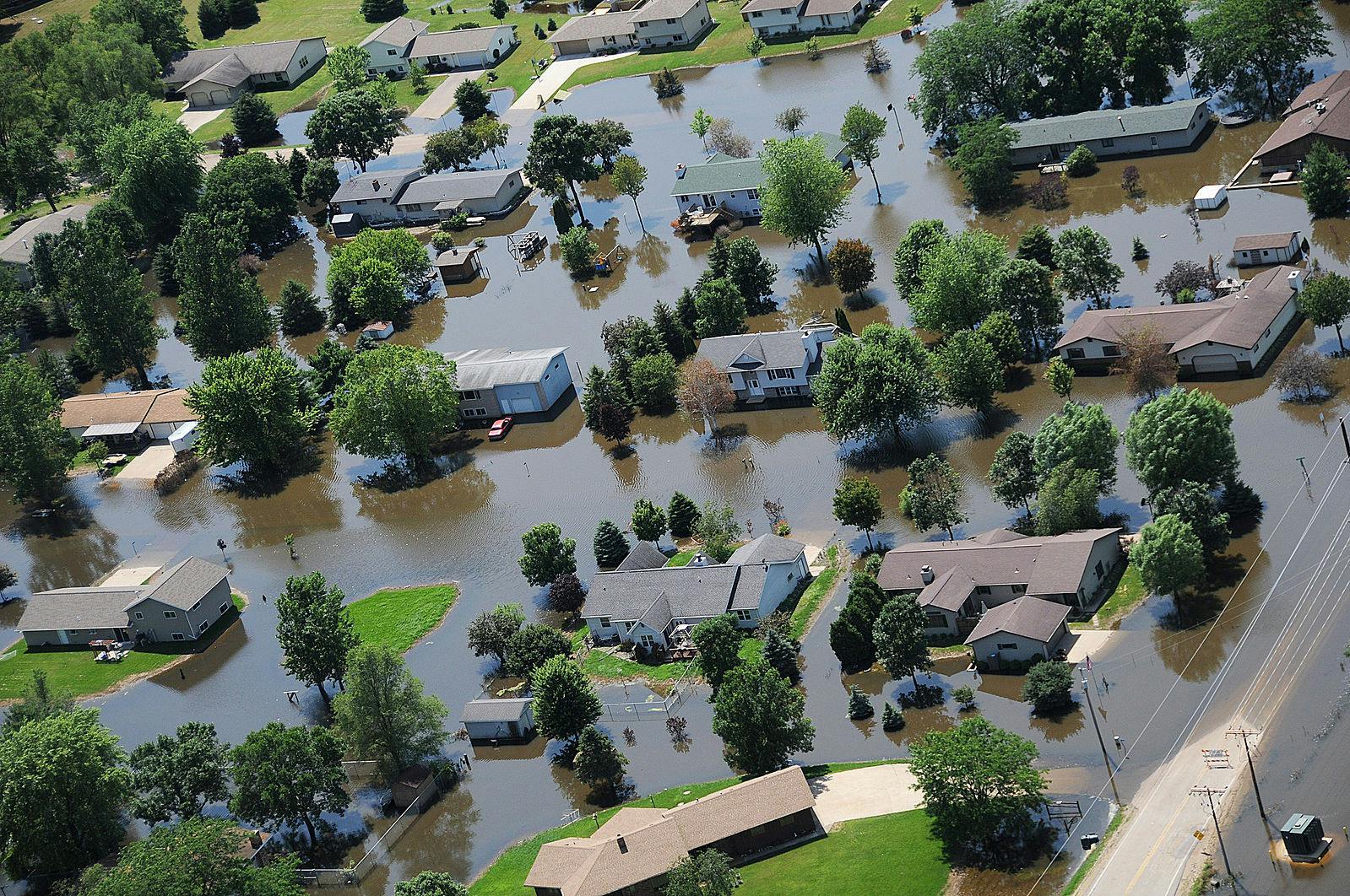 Climate change may lead to an increase in insurance costs for homeowners if the temperature keeps rising (Photo courtesy of Wikimedia Commons/“FEMA - 37141 - Aerial of flooded homes in Wisconsin” by Walter Jennings. July 11, 2008). 