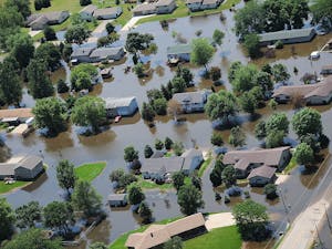 Climate change may lead to an increase in insurance costs for homeowners if the temperature keeps rising (Photo courtesy of Wikimedia Commons/“FEMA - 37141 - Aerial of flooded homes in Wisconsin” by Walter Jennings. July 11, 2008). 
