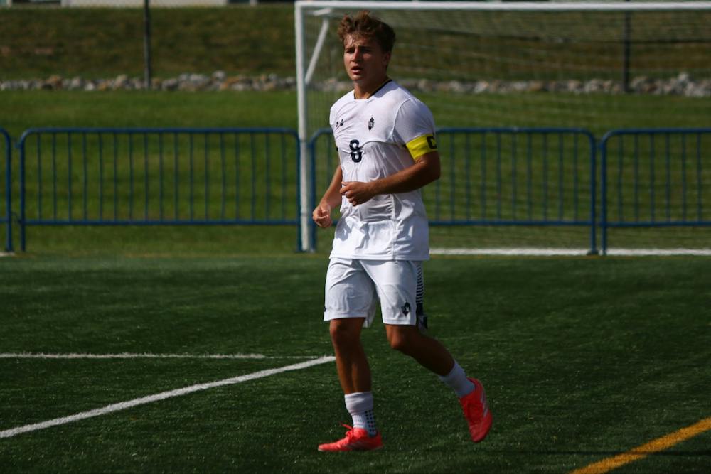 Sophomore Aidan Grund completes a pass against Farmingdale State