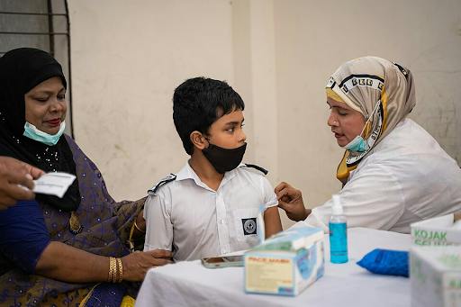Measles vaccines are being administered to children in Bangladesh via immunization campaigns assisted by global health organizations. (Photo courtesy of Wikimedia Commons)