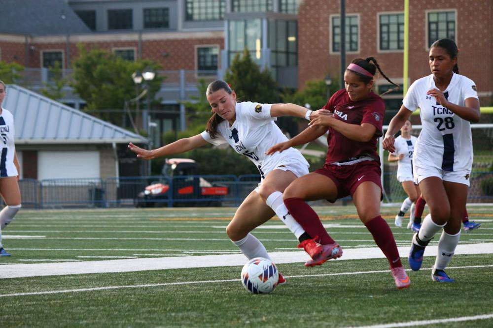 Junior Jenny Ward battles for the ball against Arcadia