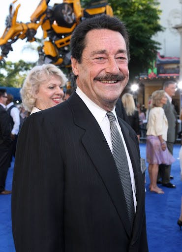 Voice actor Peter Cullen at an event celebrating the 2007 live-action “Transformers” movie. In the background is a model of the “Transformers” character Bumblebee. (Photo courtesy of IMDb)
