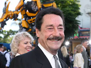 Voice actor Peter Cullen at an event celebrating the 2007 live-action “Transformers” movie. In the background is a model of the “Transformers” character Bumblebee. (Photo courtesy of IMDb)