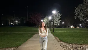 Freshman nursing major Olivia White walks back to Wolfe Hall after class in April. (Photo by Isabella McHugh)