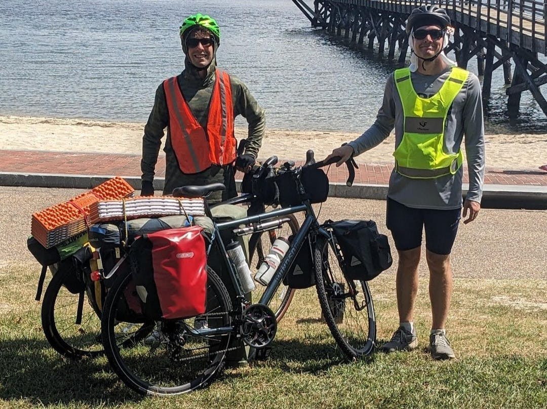 Matthew Smith and Mark Koerner in Yorktown, Virginia at the beginning of their trip through the TransAmerica bike trail (Photo courtesy of @mattandmarkcrossamerica via Instagram. August 26, 2023).