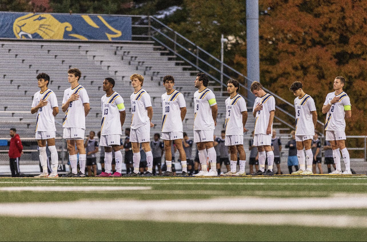 The College's starters during the national anthem before the game (Photo courtesy of Derick Zelaya).