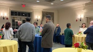 Students of the Campus to Capitol Mentorship Program talking to their mentors at a kick-off party on Feb. 4. (Photo by Franc Romanowski)