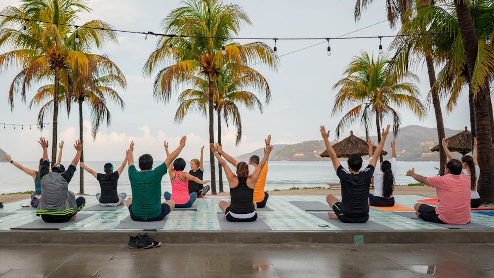 <p><em>Veterans seek psychedelic treatment for post-traumatic stress disorder in Mexico. (Photo courtesy of </em><a href="https://commons.wikimedia.org/wiki/File:Morning_Yoga_at_Pool,_Palm_Trees,_Beach_at_Thompson_Zihuatanejo_(48068219982).jpg" target="_blank"><em>Wikimedia Commons</em></a><em> / Nan Palmero, June 8, 2019)</em></p>