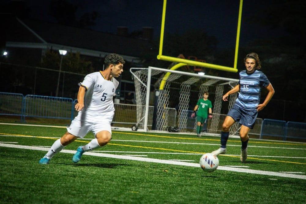 <p><em>Junior Conor Campbell faces off with an Immaculata defender. (Photo by Andre Paras / Video Editor)</em></p>