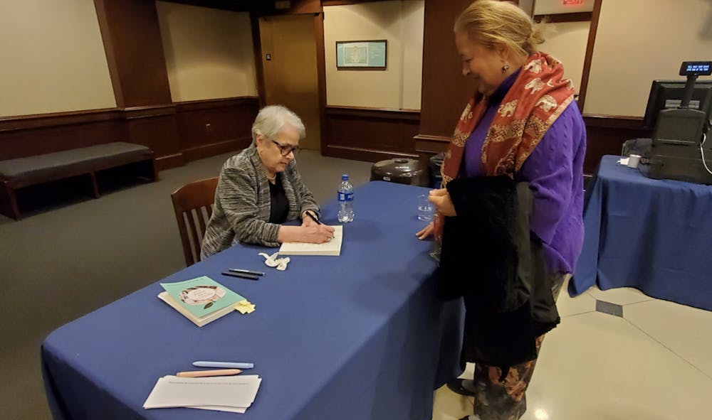 <p>R. Barbara Gitenstein signing book of TCNJ alumnae Carole Bridges (Photo courtesy of Catherine Gonzalez / Correspondent). <br/></p>