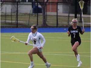 (M/D Wayden Ay floats by defender on her way to 4 points and 7 ground balls. Photo courtesy of Joey Bachich).