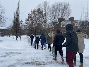 Students are seen walking through the snow after a storm swept through the College (Karla Fonseca / Staff Writer).