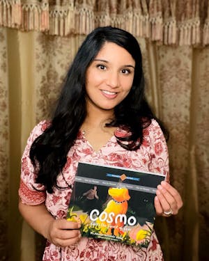 Amulya Veldanda holding a picture of her book (photo courtesy of Amulya Veldanda).
