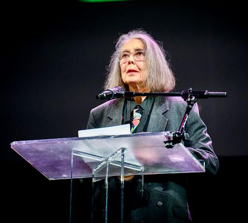 Anne Carson reading in the New York University Skirball Center at the 2024 National Book Awards. (Photo courtesy of Wikimedia Commons)