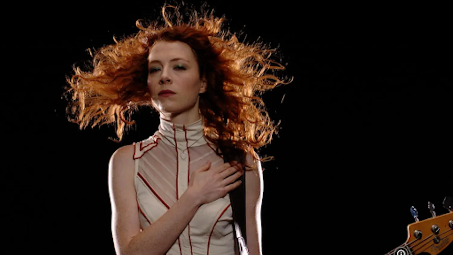 Melissa Auf der Maur poses formidably with her guitar for the camera. (Photo courtesy of IMDb)