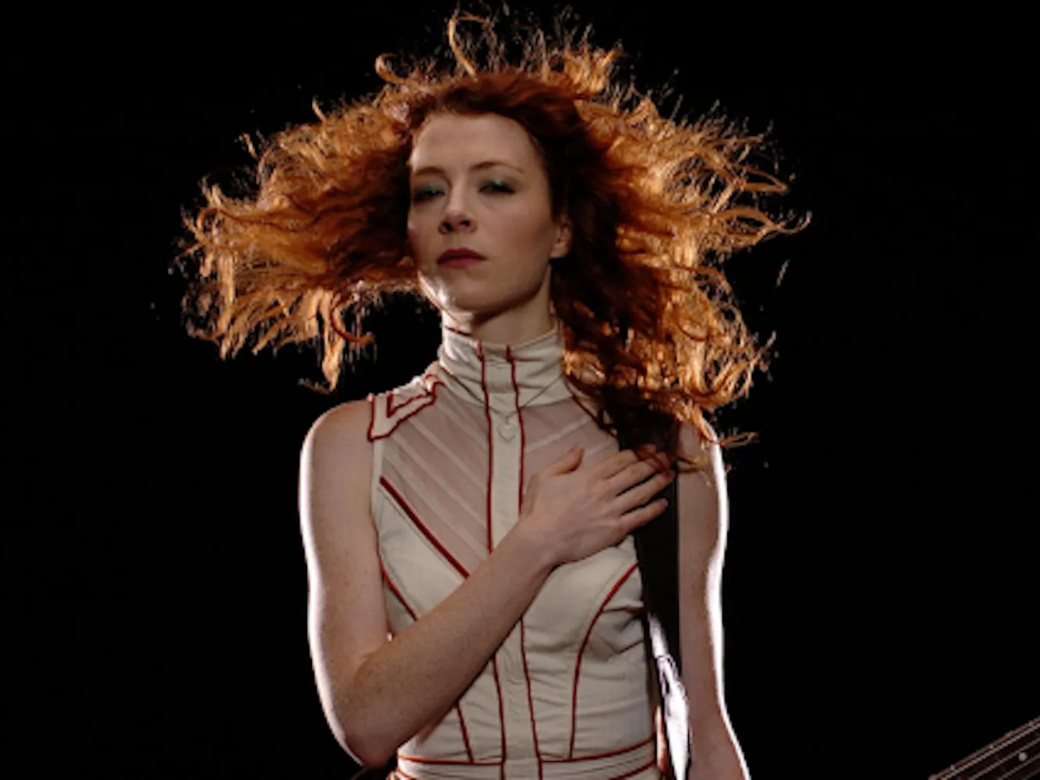 Melissa Auf der Maur poses formidably with her guitar for the camera. (Photo courtesy of IMDb)