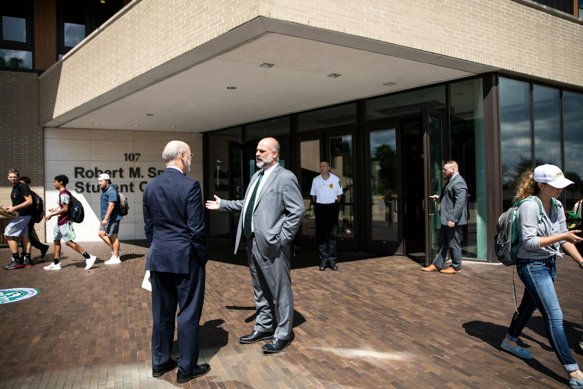 Slippery Rock University President William Behre (right) talking to former Pennsylvania Governor Tom Wolf (left) in 2019 (Courtesy of Flickr / “Gov. Wolf Joins Slippery Rock University in Fight Against Campus Sexual Assault” by Governor Tom Wolf. Sept. 4, 2019.)