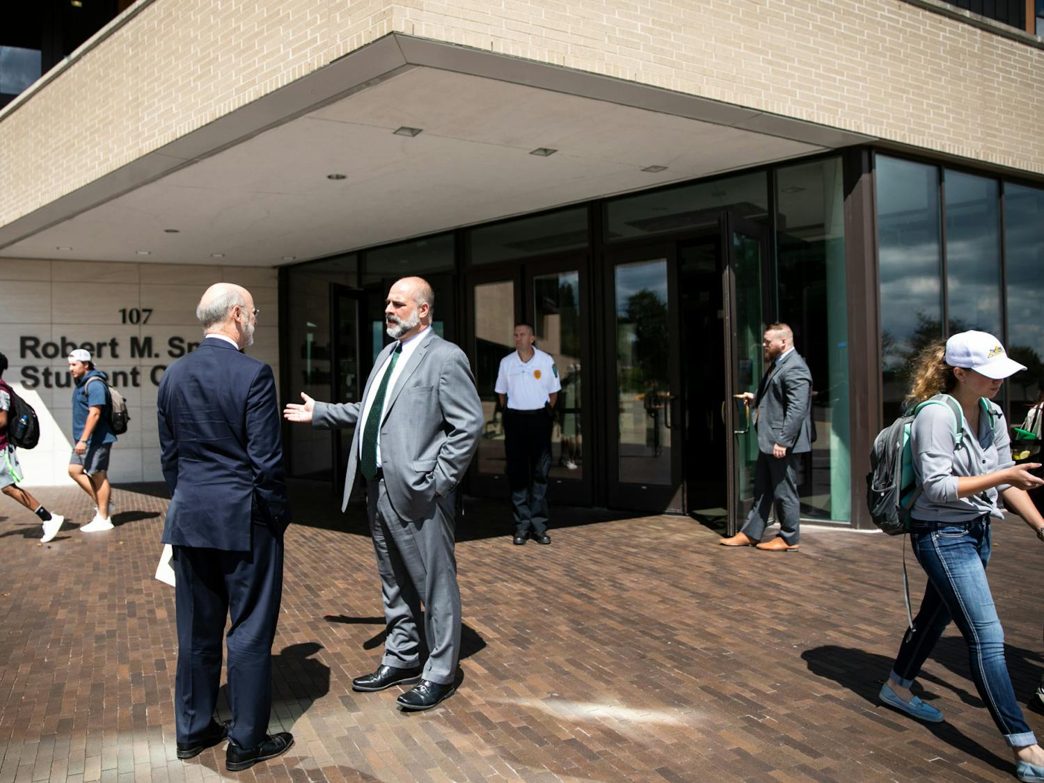 Slippery Rock University President William Behre (right) talking to former Pennsylvania Governor Tom Wolf (left) in 2019 (Courtesy of Flickr / “Gov. Wolf Joins Slippery Rock University in Fight Against Campus Sexual Assault” by Governor Tom Wolf. Sept. 4, 2019.)