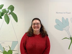 Leann Janzekovich standing in front of a Lonicera Morrowii honeysuckle diagram. (Photo Courtesy of Jasmine Lee / Staff Writer) 