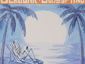 A skeleton sits on the beach staring at a phone in the art for Superchunk’s new record. (Photo courtesy of Apple Music)
