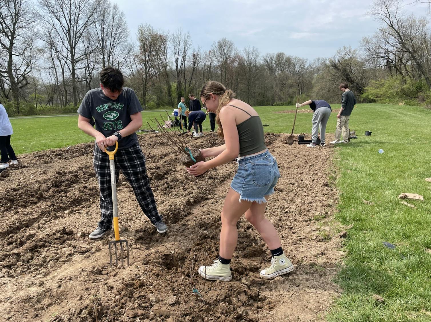 Students planting in one of two tilled plots located behind the soccer field and Decker Hall (Photo courtesy of Parisa Burton).
