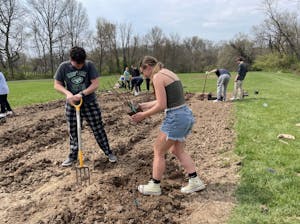 Students planting in one of two tilled plots located behind the soccer field and Decker Hall (Photo courtesy of Parisa Burton).