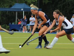 A Lions player keeping the ball away from two defenders (Photo courtesy of Elizabeth Gladstone).
