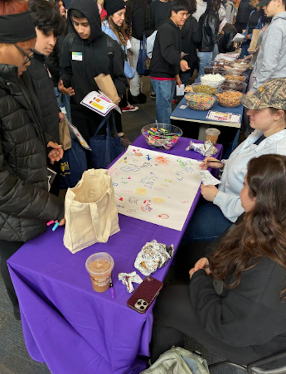 <p><em>Dr. Martin Luther King Jr. Middle School students visit information stations at The College of New Jersey in March. (Photo courtesy of Marissa Bellino)</em></p><p></p>