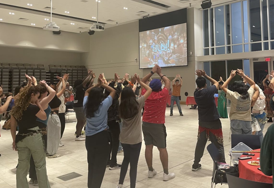 Students participating in interactive belly dance performance (Photo courtesy of Parisa Burton).