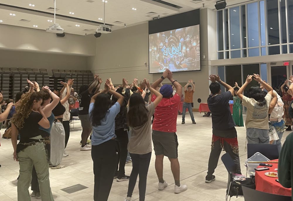 <p><em>Students participating in interactive belly dance performance (Photo courtesy of Parisa Burton).</em></p>