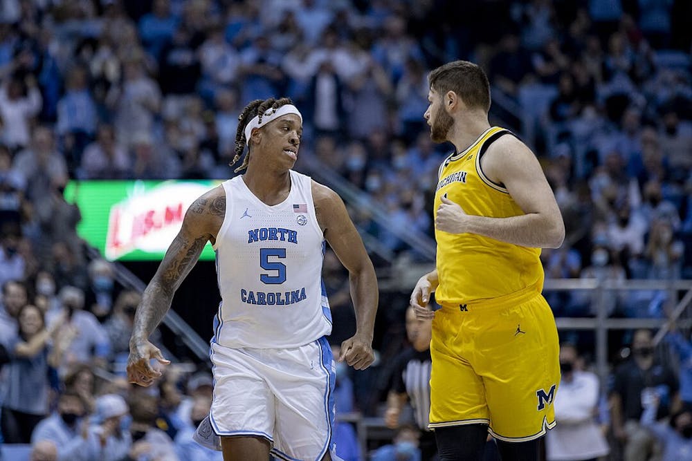 <p>UNC center Armando Bacot and now Kansas center Hunter Dickinson when he was at Michigan (Photo courtesy of MGoBlog / <a href="https://www.flickr.com/photos/mgoblog/51718989173/" target="_blank">Flickr</a>).</p>