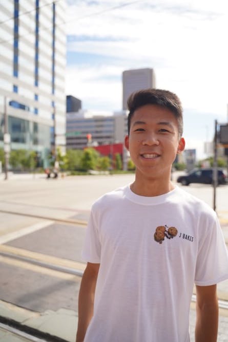 Yuen smiling for a photo in his J Bakes merch (Photo courtesy of Justin Yuen).