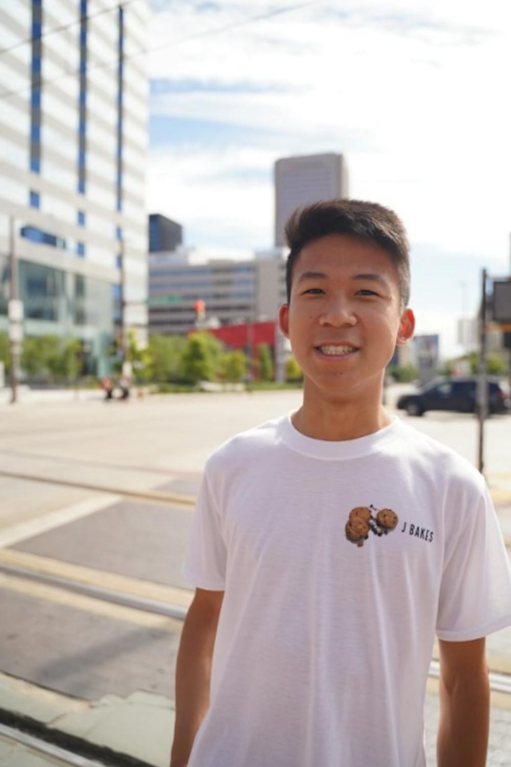 Yuen smiling for a photo in his J Bakes merch (Photo courtesy of Justin Yuen).