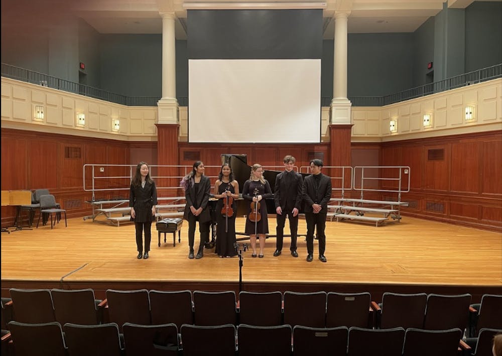 <p>Performers stand together to bow after a piano and violin recital (Photo courtesy of Isabella Darcy / Staff Writer). </p><p><br/><br/><br/></p>