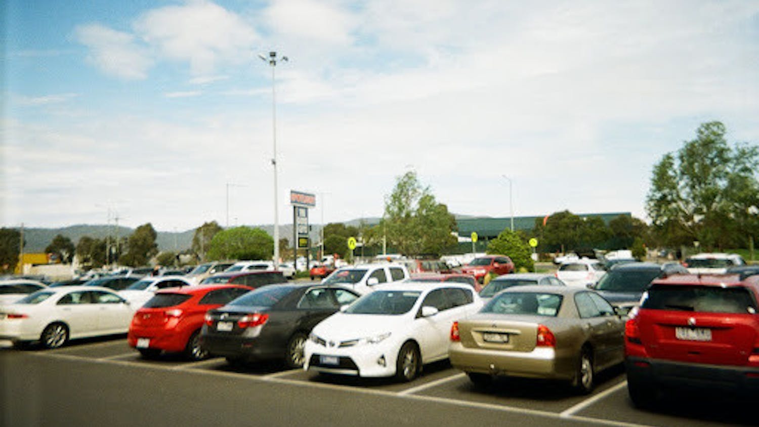 Commuters often need to devote extra time to driving and finding a parking space. (Photo courtesy of Flickr / “2018 Parking Lot” by Matthew Paul Argall / October 30, 2018).