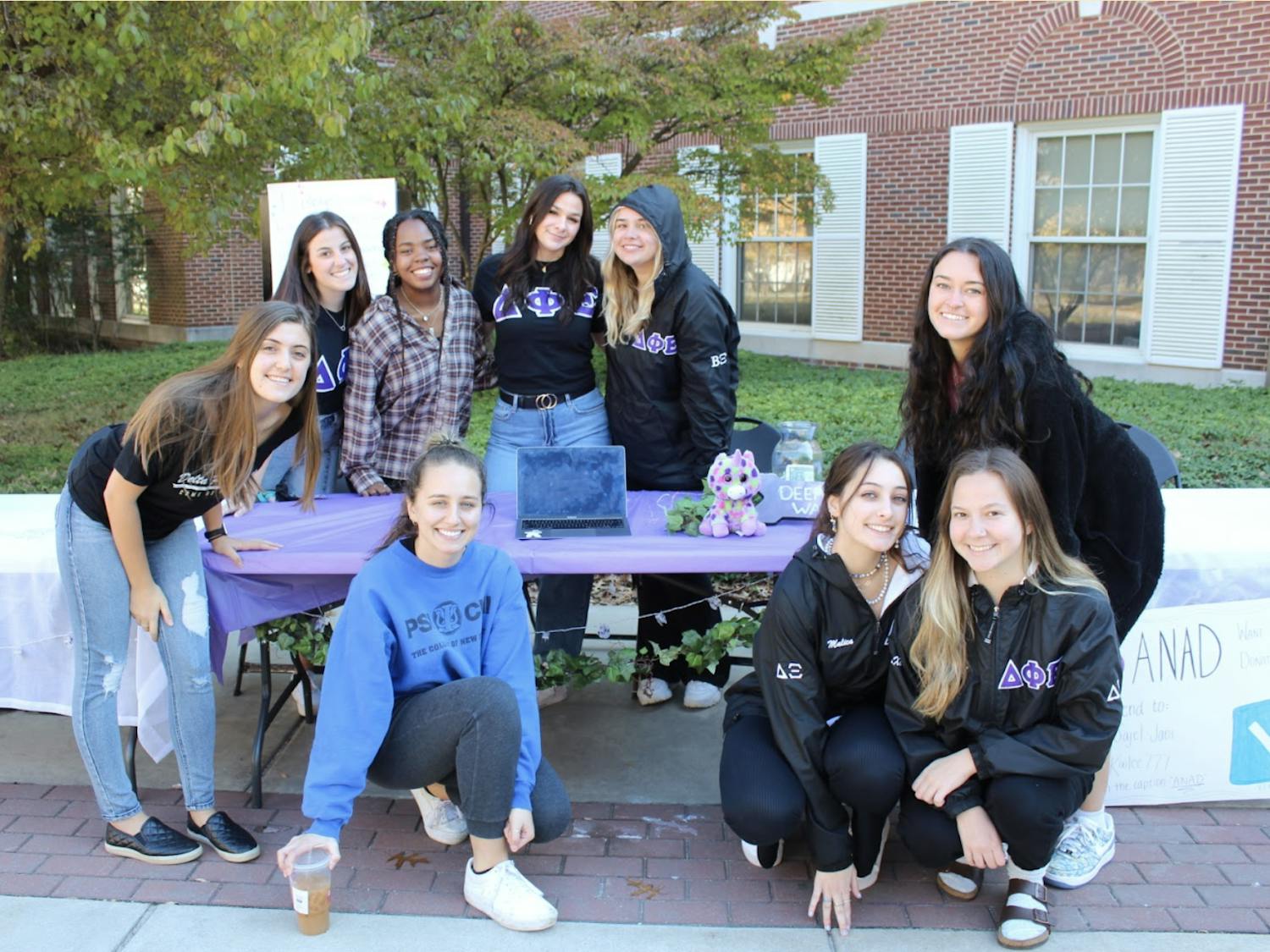 Members of Delta Phi Epsilon pose for their tabling event outside of Eickhoff Hall during ANAD week (Elizabeth Gladstone / Photographer).