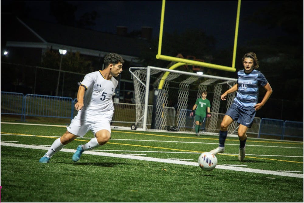 <p><em>Junior Conor Campbell faces off with an Immaculata defender. (Photo by Andre Paras / Video Editor)</em></p>
