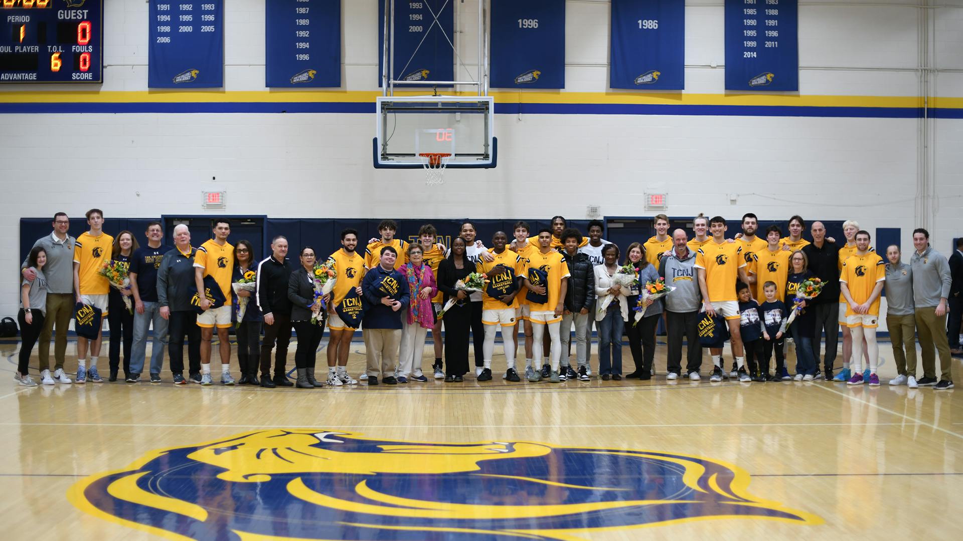 The College's men's basketball team with the families of the seniors (Photo courtesy of Jimmy Alagna).