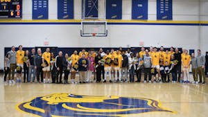 The College's men's basketball team with the families of the seniors (Photo courtesy of Jimmy Alagna).