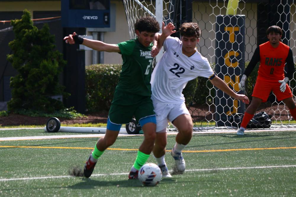 Sophomore Aidan Ayar battles for the ball against Farmingdale State