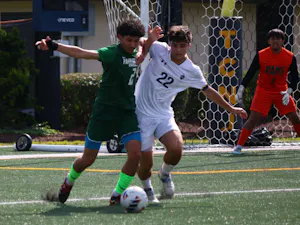 Sophomore Aidan Ayar battles for the ball against Farmingdale State