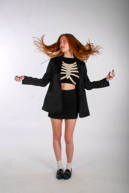 Outfit Pictured: Blazer and Skirt, TJ Maxx. Black Crop Tank, Cotton on. Skeleton Sweater, Etsy. Socks, Walmart. Shoes, Vintage Sam and Libby (Photo courtesy of Jessie Bodnar)
