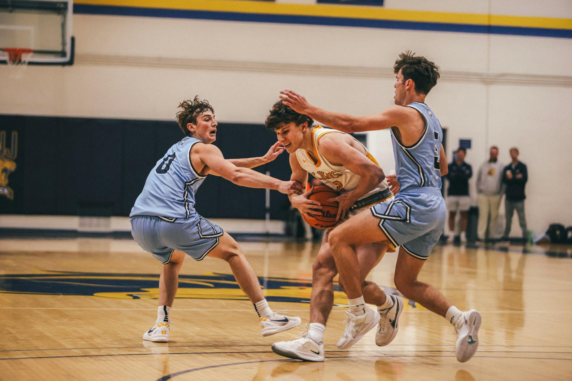 Nick Koch controlling the ball between two defenders (Photo courtesy of Arion Owes).﻿