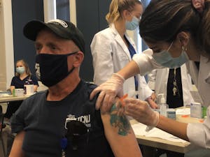A faculty member gets his Moderna booster shot at the clinic (Delaney Smith / The Signal).